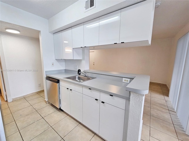 5740 Rock Island Rd Unit 274, Tamarac, FL 33319 - kitchen with stainless steel dishwasher, light countertops, white cabinetry, a sink, and light tile patterned floors