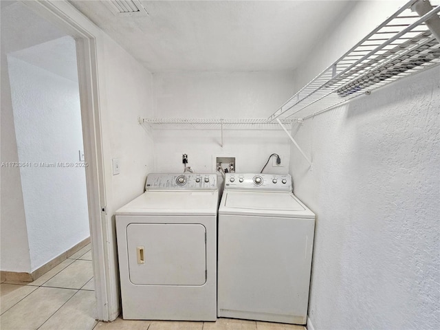 5740 Rock Island Rd Unit 274, Tamarac, FL 33319 - laundry area featuring baseboards, laundry area, light tile patterned flooring, and washer and clothes dryer