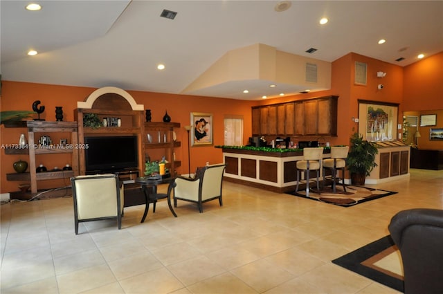 living room with vaulted ceiling and light tile patterned floors