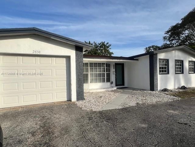 single story home with a garage