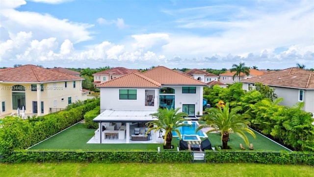 back of house with an outdoor living space, a balcony, and a patio area