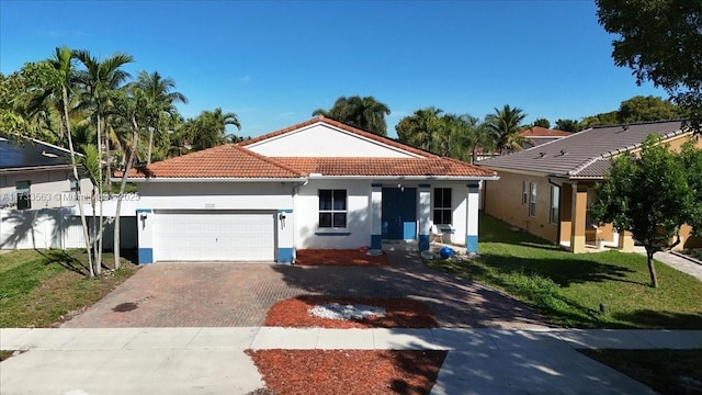 mediterranean / spanish-style house featuring a garage and a front yard