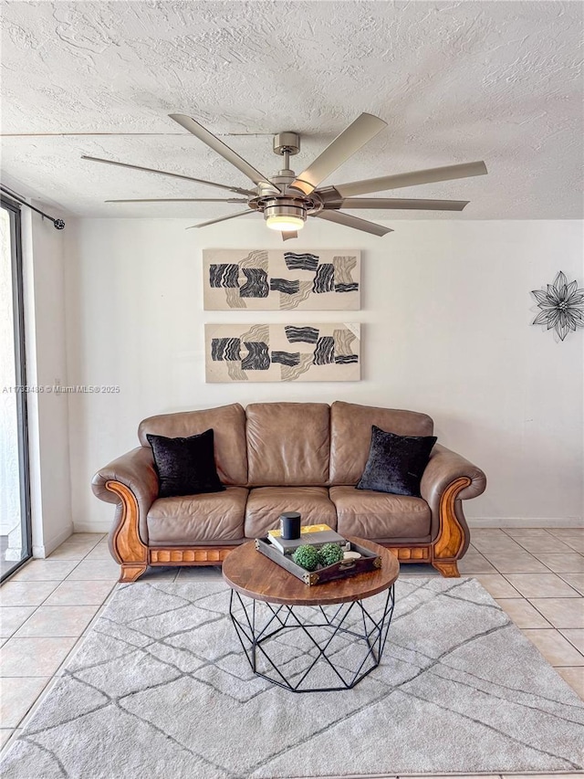 tiled living area with a textured ceiling and ceiling fan