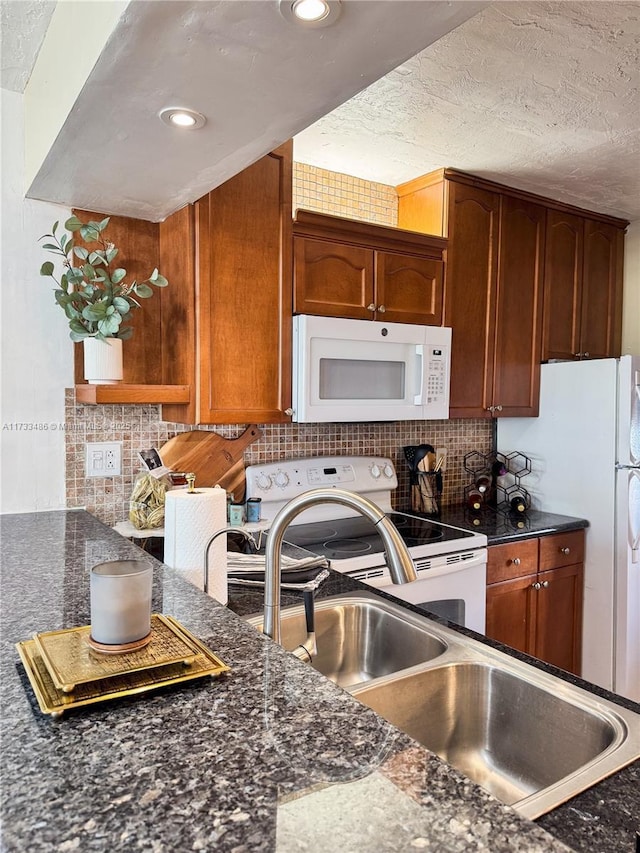 kitchen with white appliances, brown cabinetry, recessed lighting, and tasteful backsplash