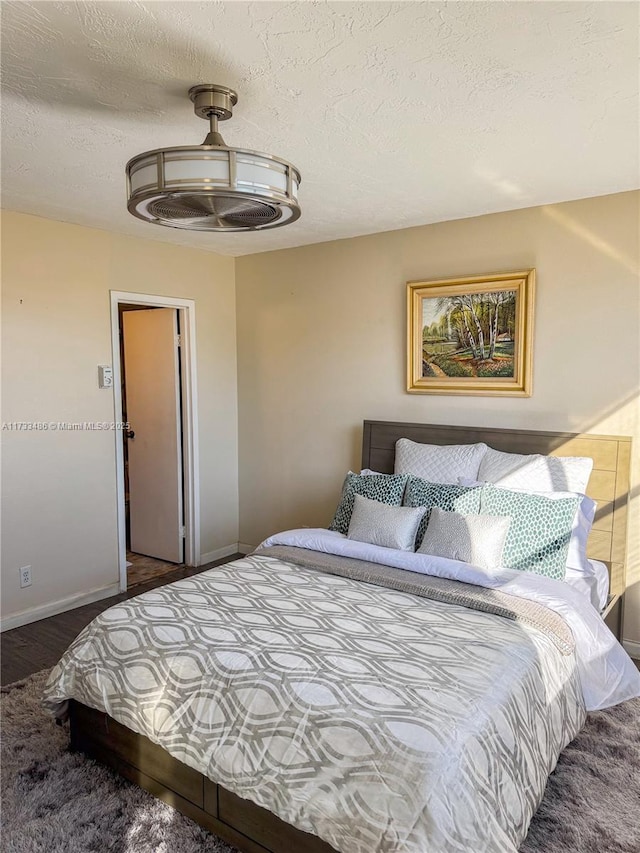 bedroom with carpet floors and a textured ceiling