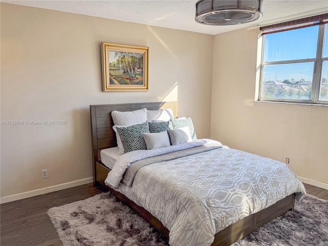 bedroom with wood finished floors and baseboards