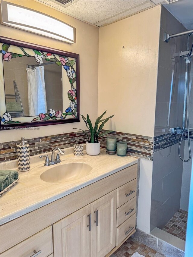 bathroom with vanity, decorative backsplash, and curtained shower