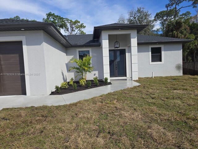 ranch-style home with a garage and a front yard