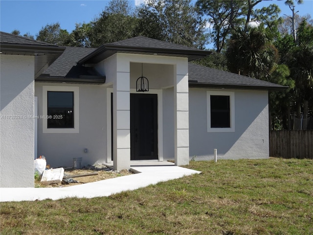 doorway to property with a yard