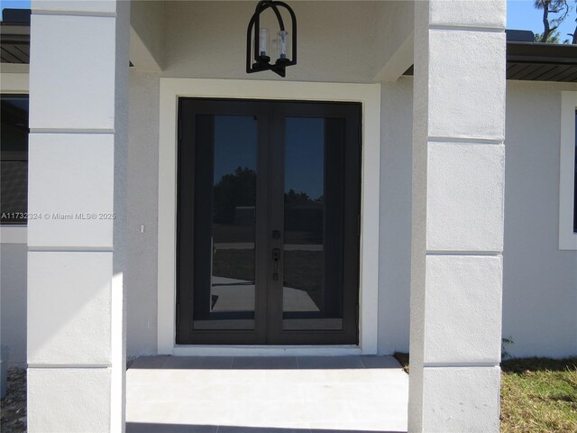 view of exterior entry featuring french doors