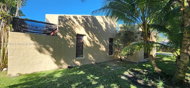 view of side of home featuring a yard