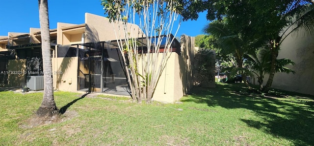 exterior space featuring cooling unit and a lawn