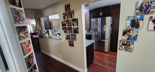 hall with dark hardwood / wood-style floors and a textured ceiling