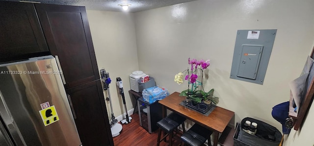 office featuring dark hardwood / wood-style flooring, electric panel, and a textured ceiling