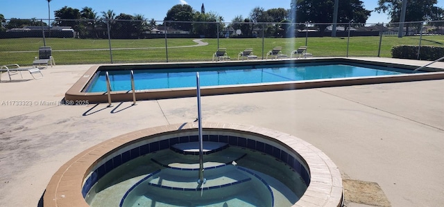 view of swimming pool with an in ground hot tub, a yard, and a patio area