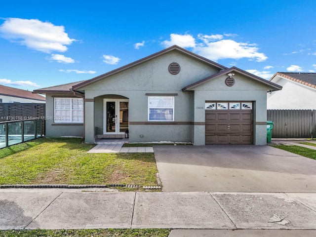 ranch-style home with a garage and a front yard