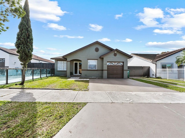 view of front of home with a garage and a front yard