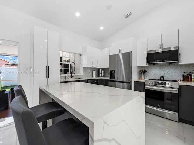 kitchen with white cabinetry, stainless steel appliances, and sink