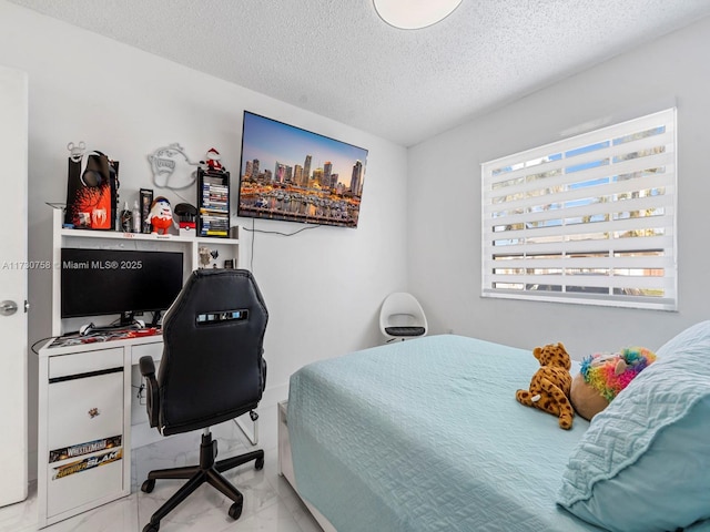 bedroom with multiple windows and a textured ceiling