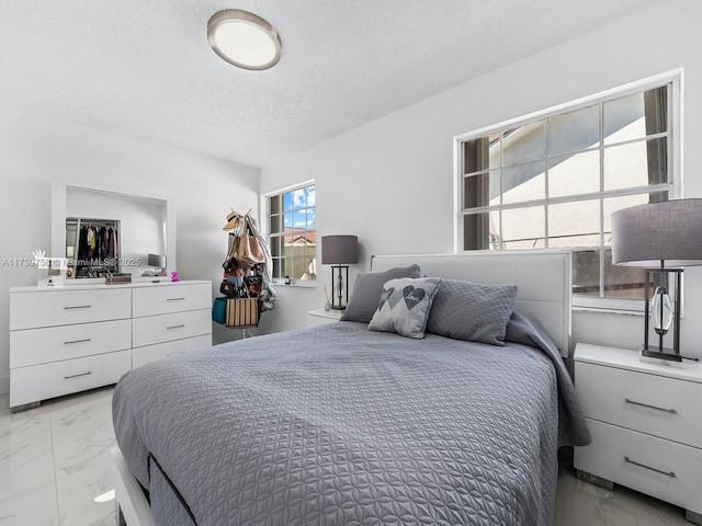 bedroom featuring a textured ceiling