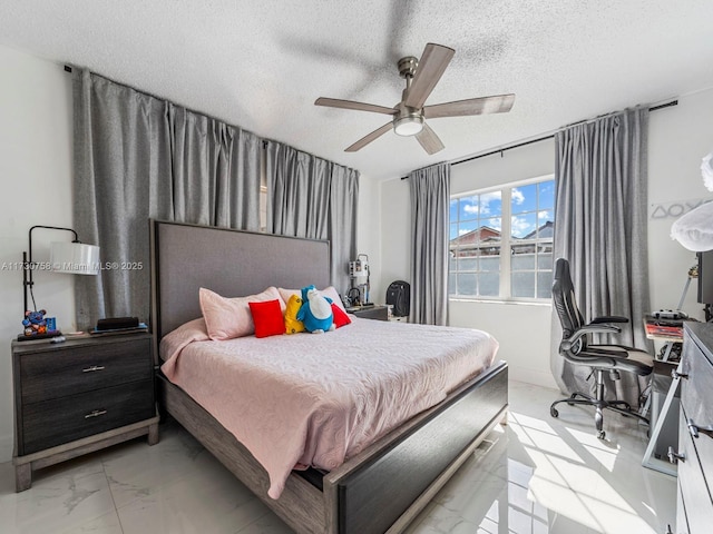 bedroom with a textured ceiling and ceiling fan