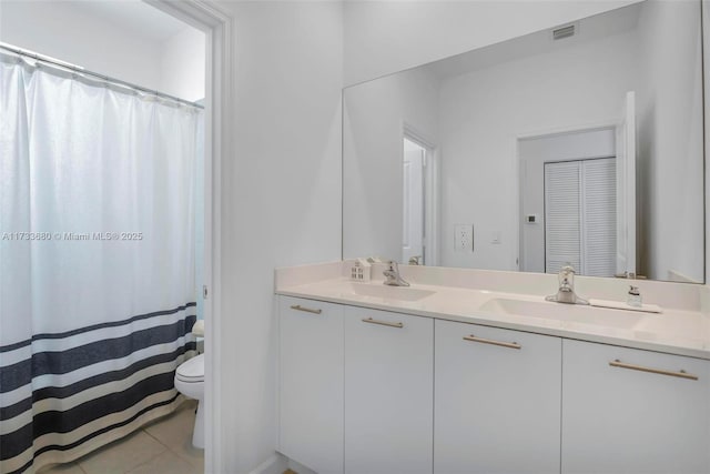 bathroom featuring tile patterned floors, toilet, and vanity