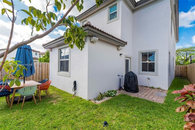 rear view of property featuring a yard