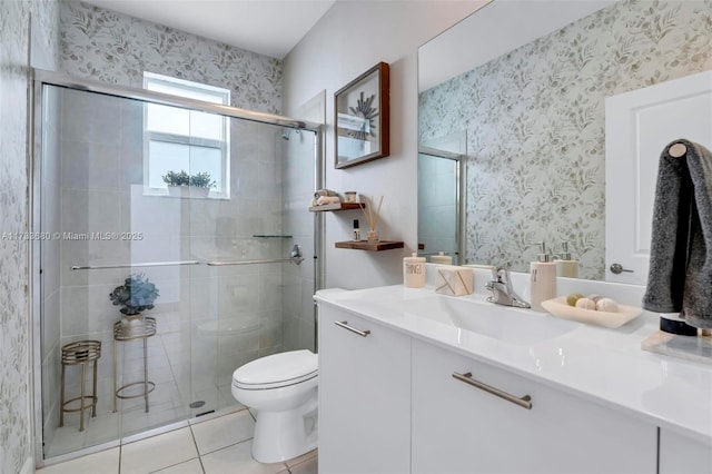 bathroom featuring walk in shower, vanity, toilet, and tile patterned flooring