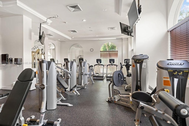 workout area featuring crown molding