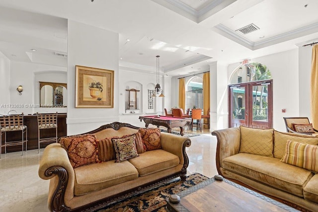 living room with a raised ceiling and ornamental molding