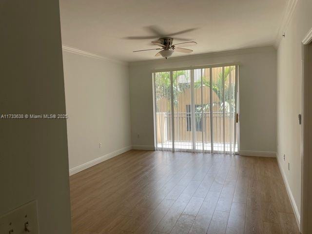 spare room with crown molding, ceiling fan, and wood-type flooring