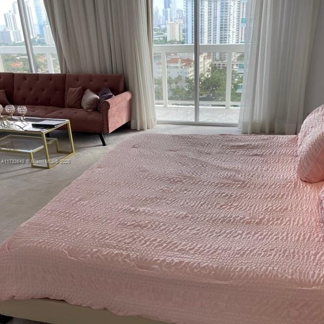 carpeted bedroom featuring multiple windows