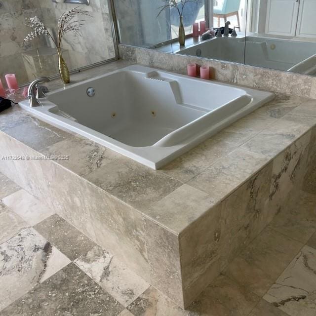 bathroom featuring tiled bath