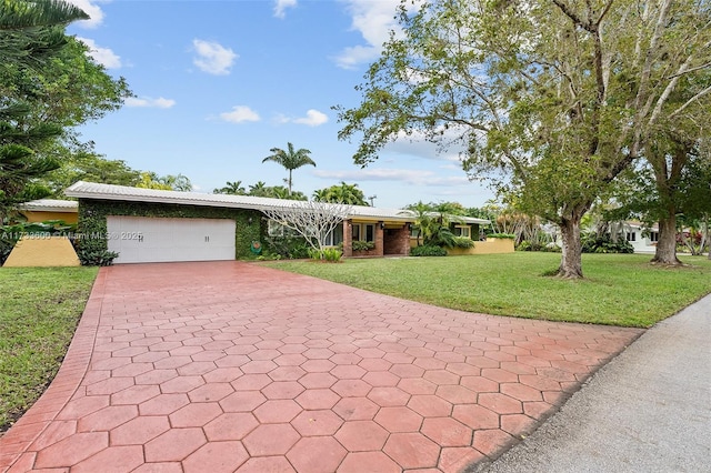 ranch-style house with a garage and a front lawn