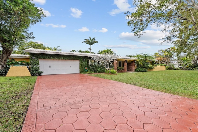 single story home with a garage and a front yard