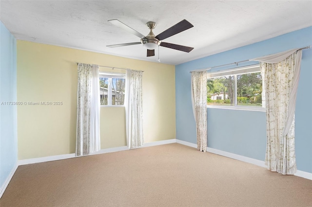 unfurnished room featuring carpet and ceiling fan