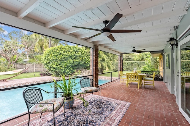 sunroom featuring ceiling fan