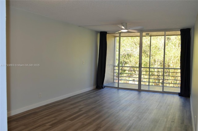 unfurnished room featuring hardwood / wood-style flooring, floor to ceiling windows, a textured ceiling, and ceiling fan