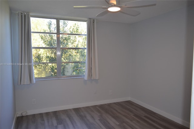 spare room with ceiling fan, a healthy amount of sunlight, and dark hardwood / wood-style floors