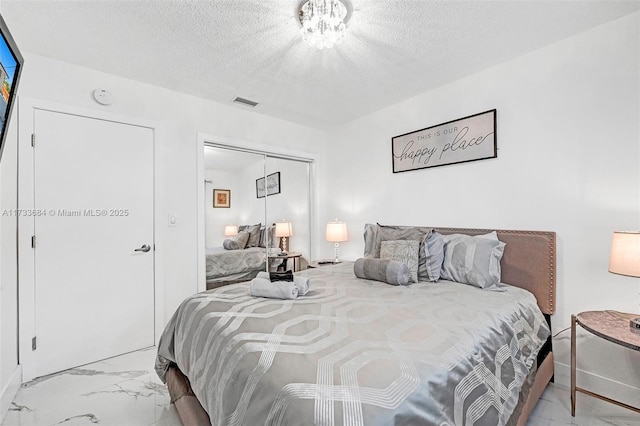 bedroom with a closet and a textured ceiling