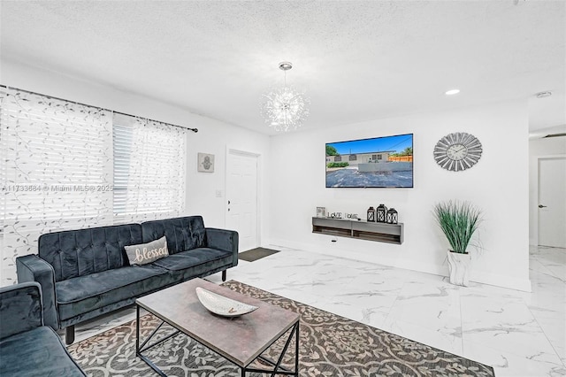 living room featuring a chandelier and a textured ceiling