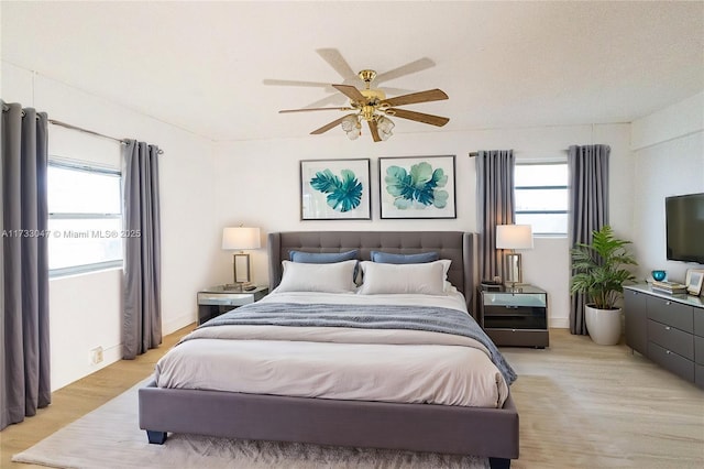 bedroom featuring light hardwood / wood-style floors and ceiling fan