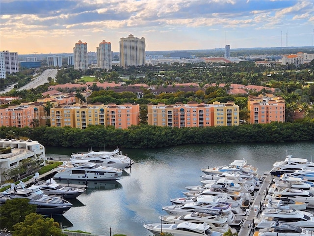 aerial view at dusk featuring a water view