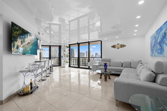 living room with light tile patterned flooring and floor to ceiling windows