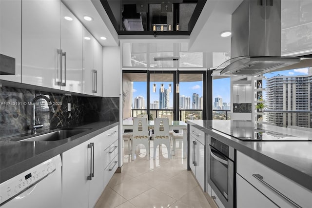 19667 Turnberry Way Unit 20B, Aventura, FL 33180 - kitchen with oven, island exhaust hood, a sink, a view of skyline, and white dishwasher