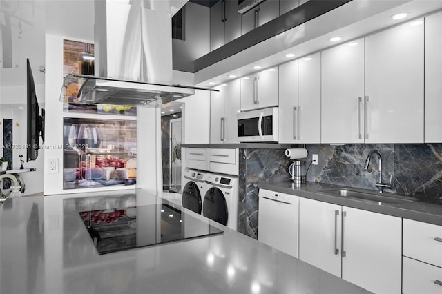 19667 Turnberry Way Unit 20B, Aventura, FL 33180 - kitchen featuring island exhaust hood, a sink, white appliances, tasteful backsplash, and white cabinetry