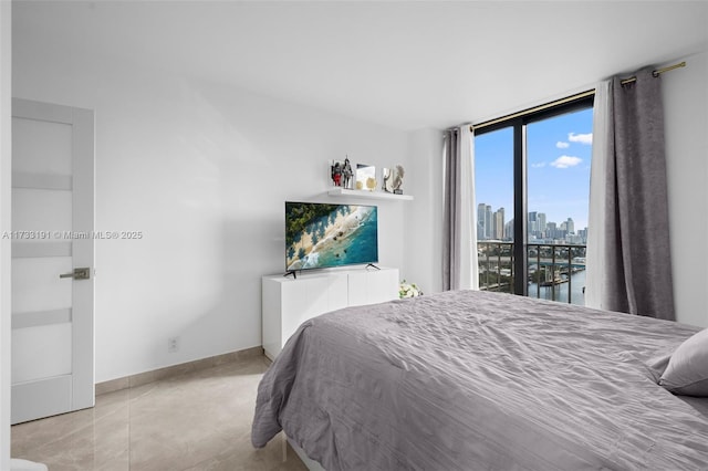19667 Turnberry Way Unit 20B, Aventura, FL 33180 - bedroom with baseboards and access to outside