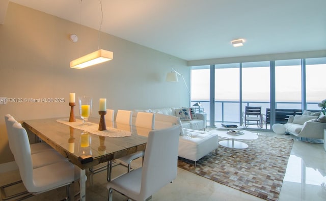 dining room featuring a water view and expansive windows