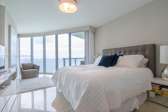 bedroom with multiple windows, floor to ceiling windows, a water view, and access to outside