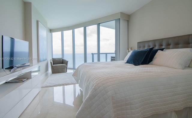 bedroom with access to outside and a water view